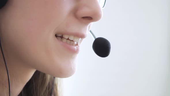 Closeup of the Face of a Young Girl Wearing Headphones Who Communicates Online Explains Teaches