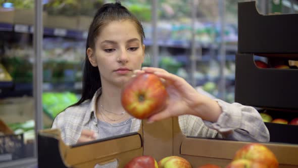 Woman Choosing Apples From Box