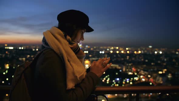 Side View Young Beautiful Tourist Woman Posting on Social Networks at Amazing Bokeh Sunset City