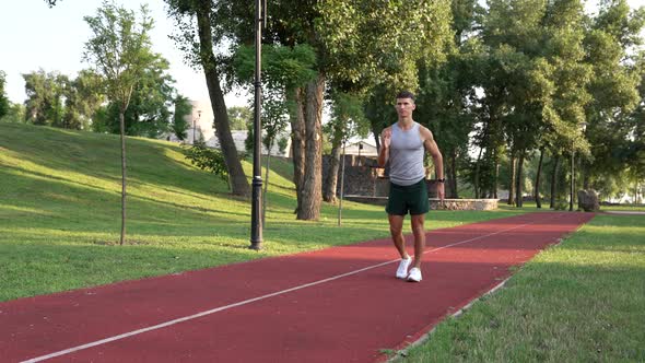 Sporty Guy Trainer Warming Up with Front Lunge Exercise Outdoor Fitness