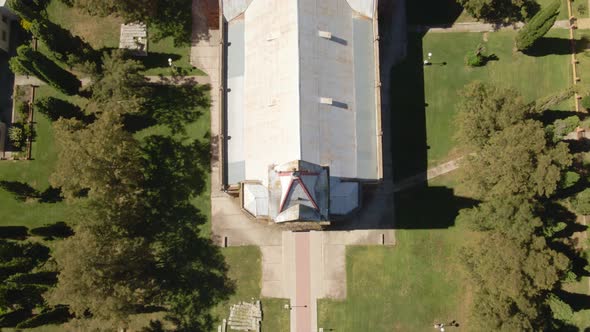 Aerial top down dolly in of an idyllic romantic style church surrounded by trees, Santa Anita, Entre