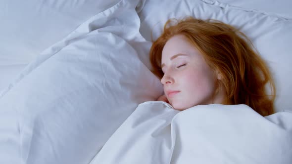 Woman sleeping in bedroom at home 