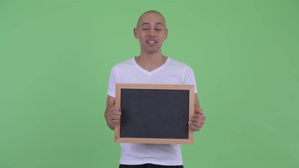 Happy Handsome Bald Man Talking While Holding Blackboard