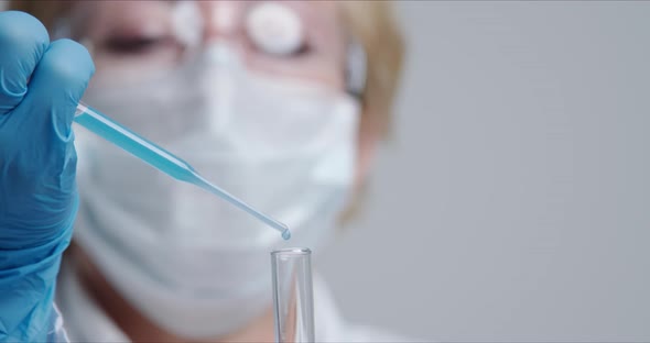 Technician Carefully Drips the Solution From the Pipette Into Glass Tubes.