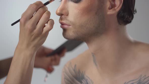 Putting Eyeshadow on Male Model