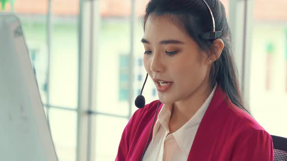 Businesswoman Wearing Headset Working Actively in Office