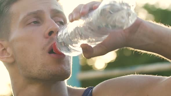 Tired Athlete Restoring Water Balance After Exhausting Workout, Slow-Motion