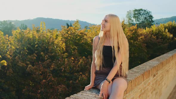 Blonde Woman Relaxing and Smiling in Sun Rays