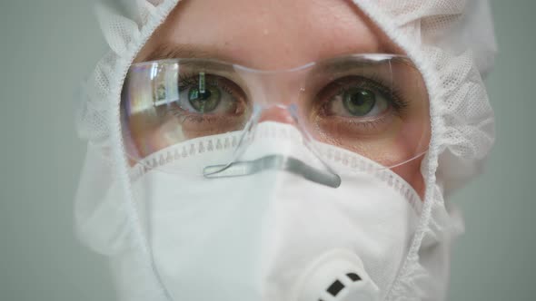 Closeup of Overworked Doctor or Researcher Dressed in Protective Suit Ppe Mask in Laboratory in