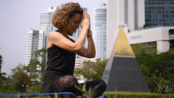 Healthy Lifestyle Of Grateful Woman Doing Yoga In City Park