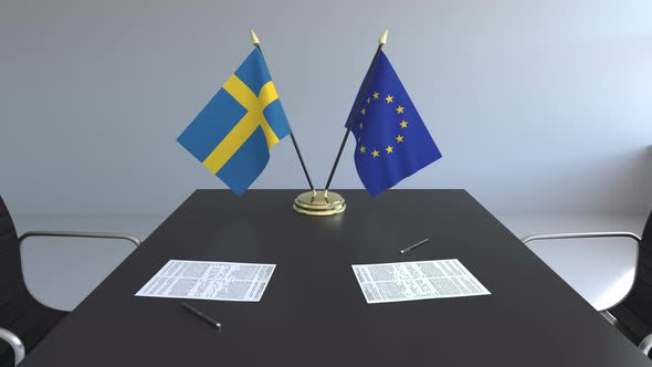 Flags of Sweden and the EU on the Table