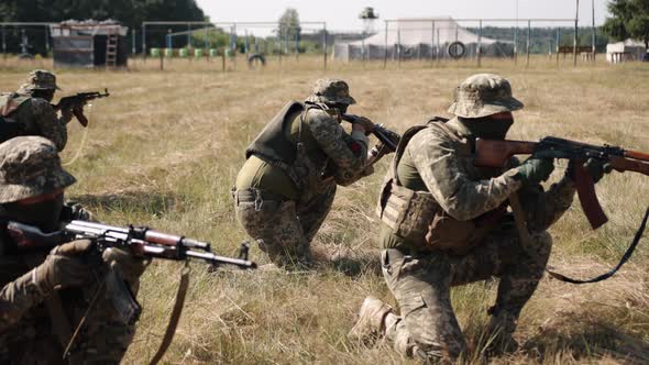 Military Special Forces Unit of Soldiers with Weapons and Ammunition are on Battlefield Attacking