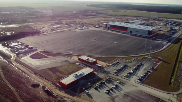 Aerial Flight Over a New Constructions Development Site Warehouses Projects and Heavy Machinery and