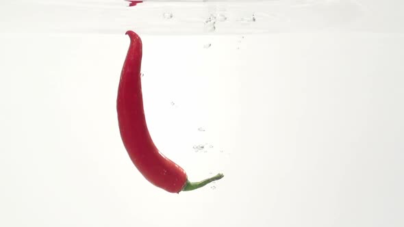 Bitter Cayenne Is in Water. Slow Motion alt