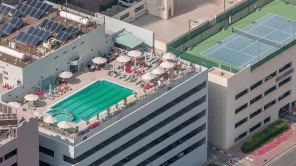 Car Parking Lot with Rooftop Swimming Pool Viewed From Above Timelapse Aerial Top View