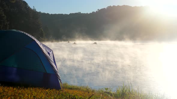 Camping Tent Near River in the Fog