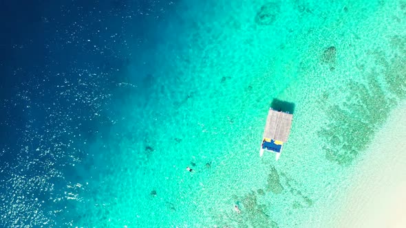 Aerial travel of idyllic tourist beach wildlife by clear sea with white sand background of a dayout 