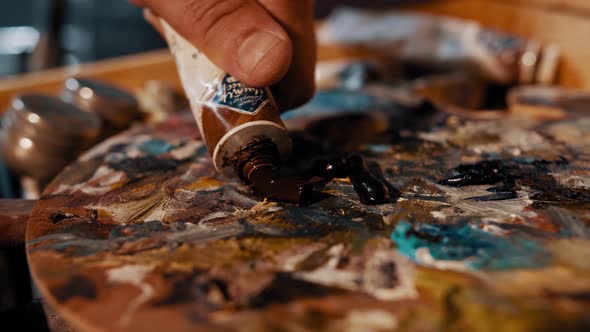 Multi-colored Wooden Palette and Paint Brush Close-up