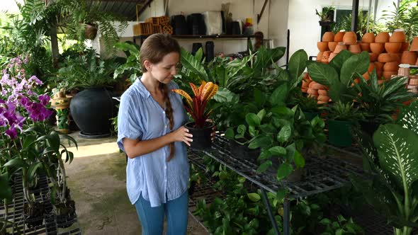 Young Woman in Casual Clothes Choosing Plants at Flower Market