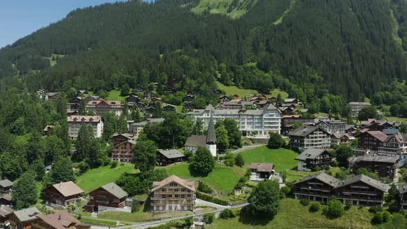 Picturesque town with alpine houses  and christian church, Switzerland