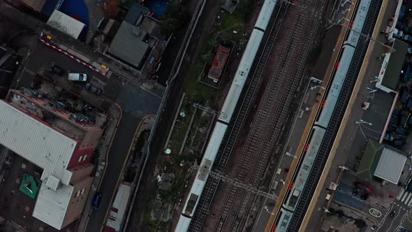 Pan up reveal drone shot of Central London Skyline from busy overground railway lines