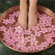 Woman putting feet in bowl of water and flowers - VideoHive Item for Sale