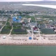 Aerial of Black Sea Shore with Lines of Lounges, Hotels, Houses and Greenery - VideoHive Item for Sale