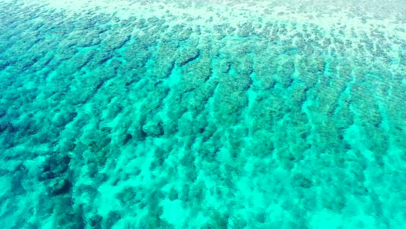 Aerial top view landscape of exotic tourist beach lifestyle by clear lagoon with white sandy backgro