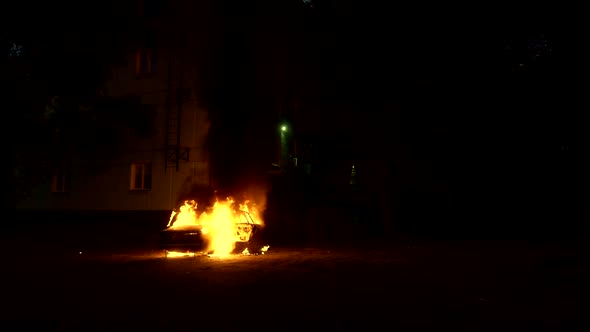 Auto on Fire Burning Near a Multistorey Building Slow Motion