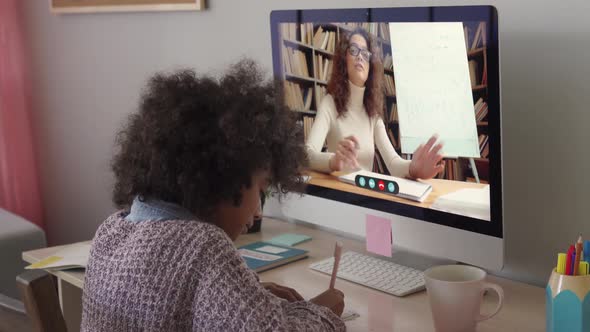 African School Kid Girl Distance Learning with Online Teacher at Home