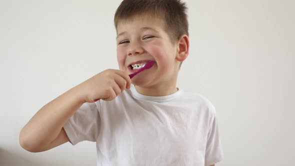 Kid Boy Brushing His Teeth Using Tooth Brush and Oral Paste Cleaning Teeth