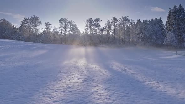 Flight over snowy landscape before sunset, Bavaria, Germany