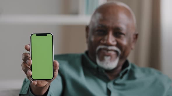 Satisfied Elderly Man Showing Green Screen on Smartphone Happy Pensioner Advertise Application
