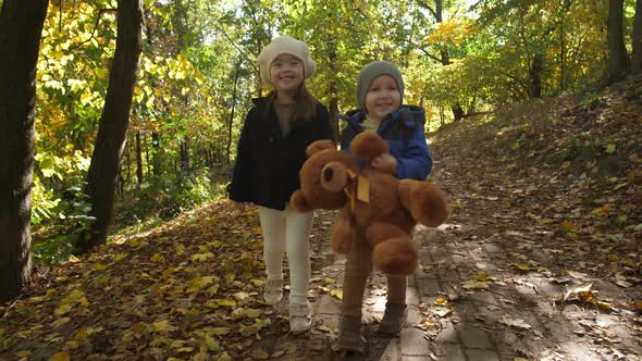 Cute Smiling Siblings Walking Hand in Hand Outdoor