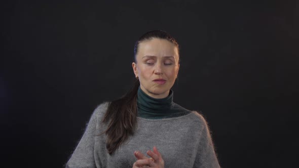 Sad Woman Wearing Blouse and Grey Sweater Looks Bewildered