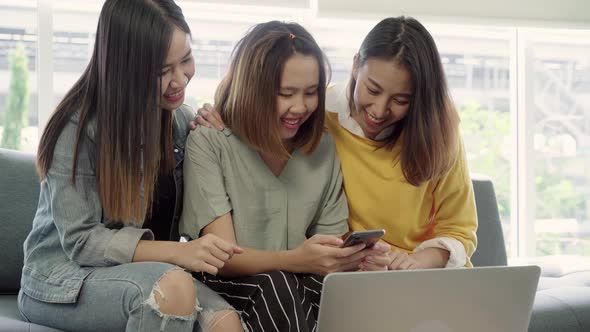 Asian women using smartphone checking social media in living room at home