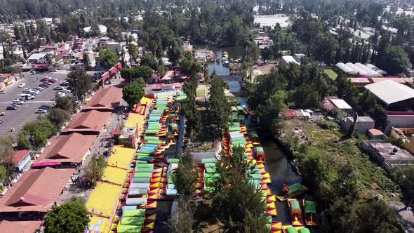 An aerial drone shot of colorful boats in Xochimilco. Tours by cannels with floating gardens in Mexi