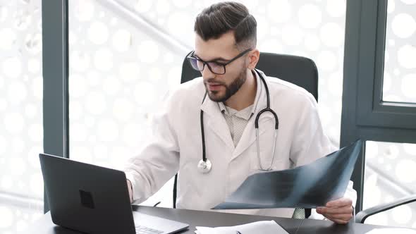 Medical Worker Looking at Xray at His Office