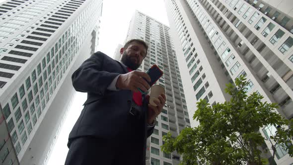 Businessman with Phone Drinking Coffee