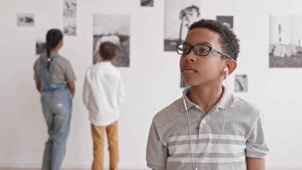 African Boy Listening to Music in Museum