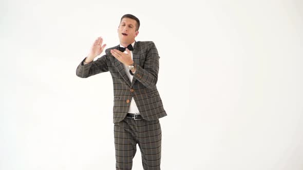 Fun Man in a Gray Checkered Suit is Showing a Scene with Money 