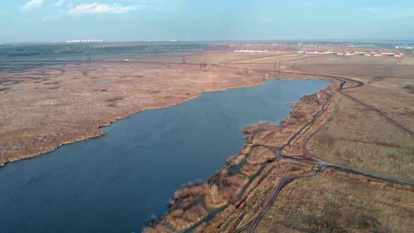 A Drone Flies Over a Lake on the Outskirts of a Texas City an Expressway Connecting the City and
