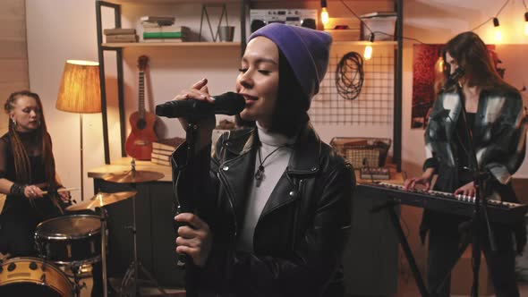 Cool Girl In Beanie Singing While Her Band Playing