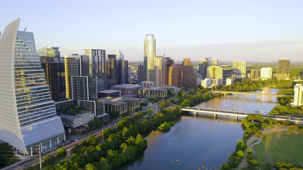 Aerial view of the riverside cityscape of sunny Austin, USA - tracking, drone shot