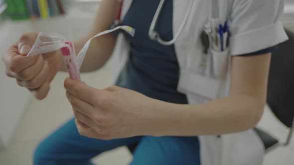 Doctor Opening Sterile Packaging To Swab For Coronavirus