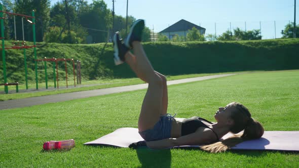 Woman Practicing Leg Raising Exercise Outdoors
