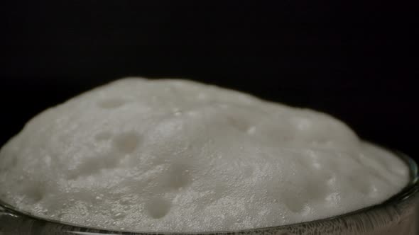 Foam Bubbling on Top of Beer Mug