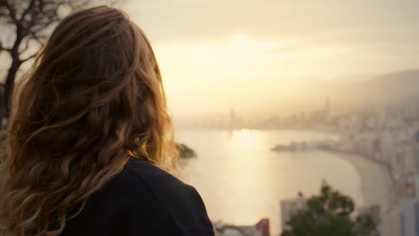 Woman Watch Sunset Over Modern High Rise City