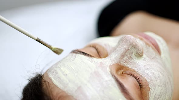 Doctor Cosmetologist or Dermatologist Making Face Mask in Cosmetology Salon