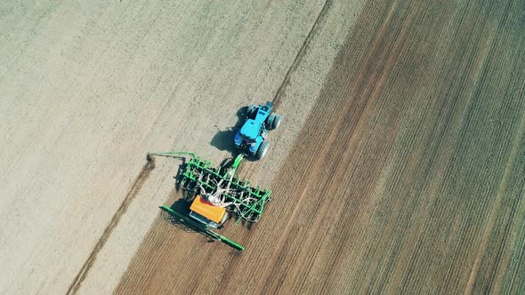 Plowing Machine Rides on a Farmland